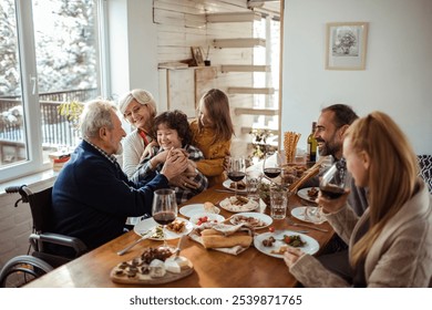 Multigenerational family gathering around the dining table at home - Powered by Shutterstock