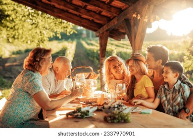 Multigenerational family having a family lunch outdoors on a patio - Powered by Shutterstock