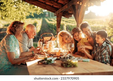 Multigenerational family having a family lunch outdoors on a patio - Powered by Shutterstock