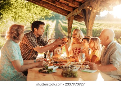 Multigenerational family having a family lunch outdoors on a patio - Powered by Shutterstock