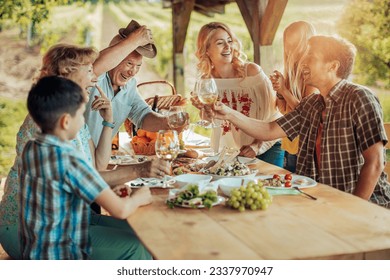 Multigenerational family having a family lunch outdoors on a patio - Powered by Shutterstock