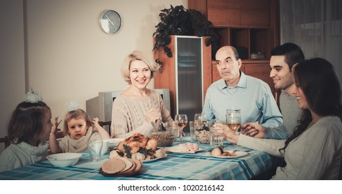 Multigenerational Family Sitting At The Table Set For Dinner