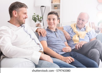 Multigenerational Family Sitting Together On A Sofa