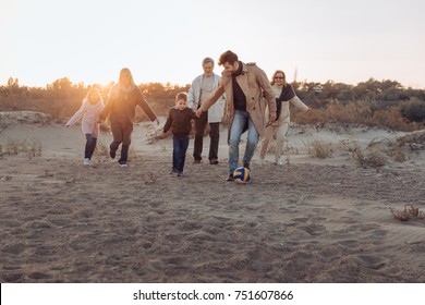 multigenerational family spending time together on seashore - Powered by Shutterstock