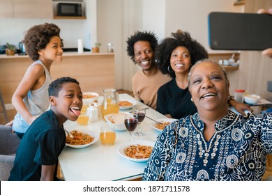 Multigenerational Family Taking Selfie With Phone At Home.