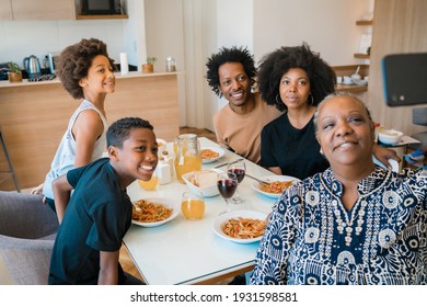 Multigenerational Family Taking Selfie With Phone At Home.