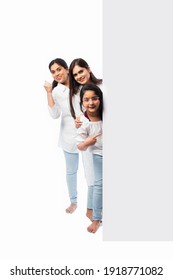 Multigenerational Indian Asian Family With White Board, Pointing Or Presenting Empty White Placard