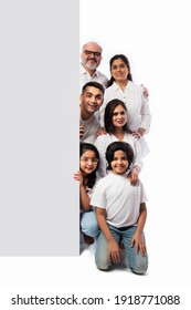 Multigenerational Indian Asian Family With White Board, Pointing Or Presenting Empty White Placard