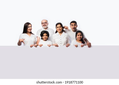 Multigenerational Indian Asian Family With White Board, Pointing Or Presenting Empty White Placard