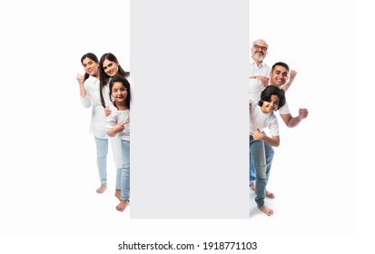 Multigenerational Indian Asian Family With White Board, Pointing Or Presenting Empty White Placard