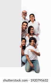 Multigenerational Indian Asian Family With White Board, Pointing Or Presenting Empty White Placard