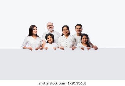 Multigenerational Indian Asian Family With White Board, Pointing Or Presenting Empty White Placard