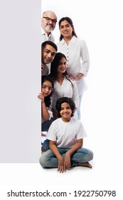 Multigenerational Indian Asian Family With White Board, Pointing Or Presenting Empty White Placard