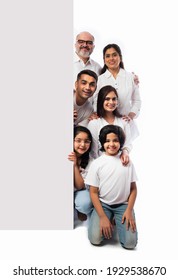 Multigenerational Indian Asian Family With White Board, Pointing Or Presenting Empty White Placard