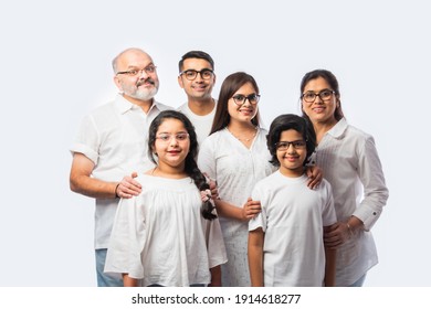 Multigenerational Indian asian smart family wears clear eye glasses or spects or spectacles against white background