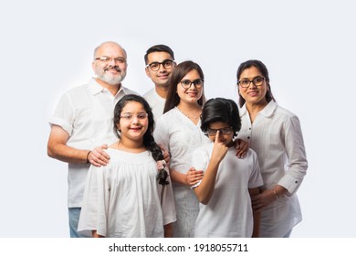 Multigenerational Indian Asian Smart Family Wears Clear Eye Glasses Or Spects Or Spectacles Against White Background