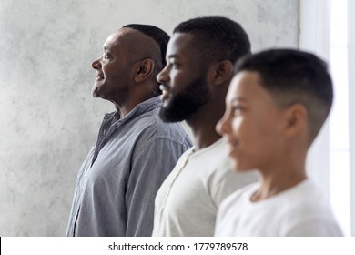 Multigenerational Men Family Portrait. Black Son, Father And Grandfather Standing In A Row, Smiling While Posing, Side View With Selective Focus