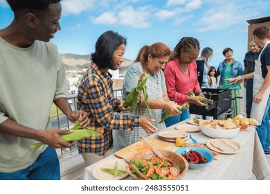 Multigenerational people doing barbecue at home's rooftop - Multiracial friends having fun eating and cooking together during weekend day - Summer and food concept - Main focus on latin woman face - Powered by Shutterstock