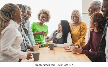 Multigenerational people having fun together inside kitchen while drinking coffee - Powered by Shutterstock