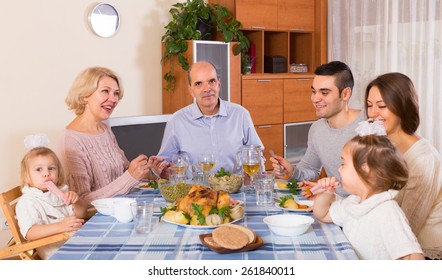 Multigenerational Positive Family Sitting At The Table Set For Dinner