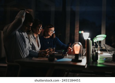 Multigenerational team working late, collaborative meeting in office setting. - Powered by Shutterstock