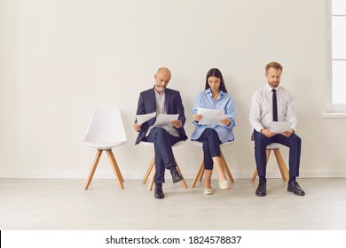 Multi-generational Workforce. Three Diverse Applicants Sitting In Queue In Office Waiting For Interview. Multiracial Job Seekers Line Up In Corridor Of Business Company. Copyspace