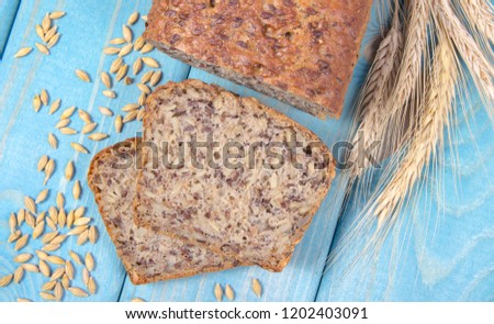 Multi-grain bread on a wooden background. The source of fiber, complex carbohydrates, B vitamins and minerals.