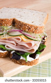 Multi-grain Bread With Sliced Turkey, Muenster Cheese, Cucumbers, Onion, Alfalfa, Lettuce, And Herb Cream Cheese Spread.