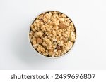 Multigrain (Cheese Creamy) granola with a mixture of nuts in white bowl on a white background. Tasty and healthy breakfast. Food made of granola and musli. Top View granola and musli.