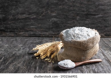 Multigrain  flour in small burlap bag on rustic wooden table 