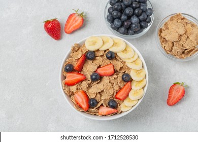 Multigrain wholegrain healthy cereal with banana and fresh berries strawberries and blueberries for Breakfast. Concept of delicious and healthy food. - Powered by Shutterstock