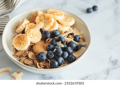 Multigrain wholewheat breakfast cereals with banana, coconut and blueberries. Vegan breakfast concept. - Powered by Shutterstock