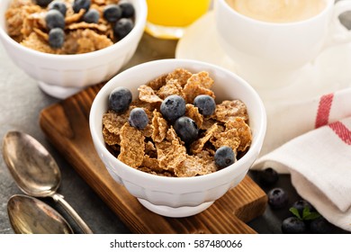 Multigrain wholewheat healthy cereals with fresh blueberry, coffee and orange juice for breakfast. - Powered by Shutterstock