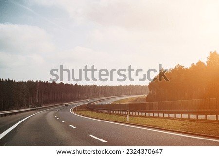 Multi-lane highway road. Road markings with white paint on asphalt. Empty interstate motorway.