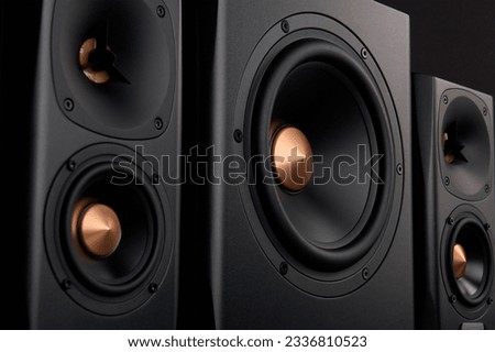 Multimedia acoustic sound speakers. Sound audio system with two satellites and subwoofer on dark background. Stereo system for listening music