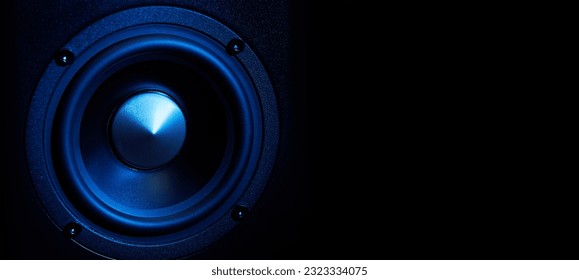 Multimedia acoustic sound speakers with blue neon lighting. Sound audio system on dark background with copy space