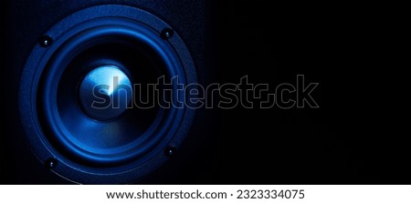 Multimedia acoustic sound speakers with blue neon lighting. Sound audio system on dark background with copy space