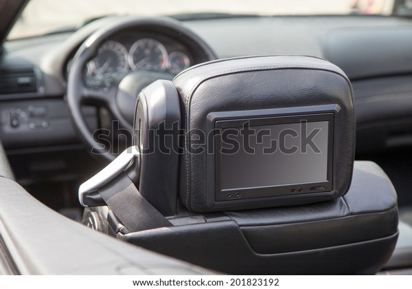 Multimedia backseat\
screen in a luxury\
car
