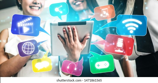 Multimedia and Computer Applications Concept. Business people using technology of digital gadget with modern graphic interface showing social, shopping, camera and multimedia application on device.