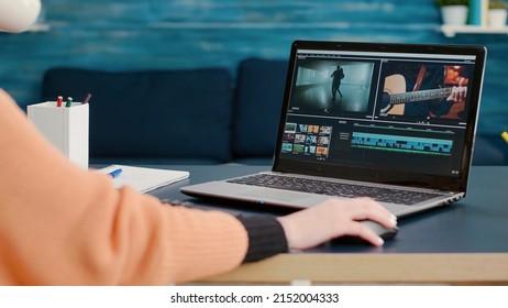 Multimedia designer using software to edit video footage on laptop at desk, learning to use production application online. Design student working on film montage to create media content. - Shutterstock ID 2152004333