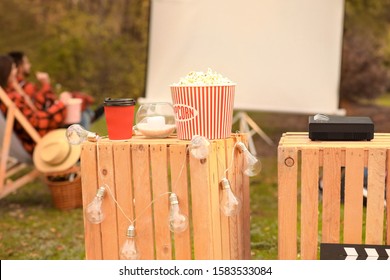 Multimedia DVD Projector With Popcorn In Outdoor Cinema