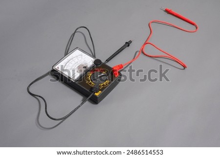 Multimeter analog or avometer analog with grey background. Tool for measuring electric current.
