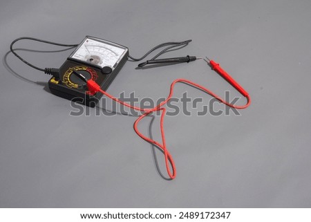 Multimeter analog or avometer analog with grey background. Tool for measuring electric current. Electric tools. 