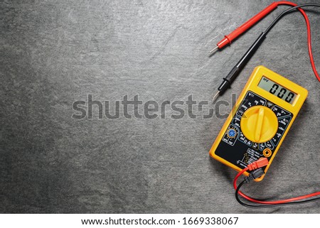 Multimeter on gray flat lay background with copy space.