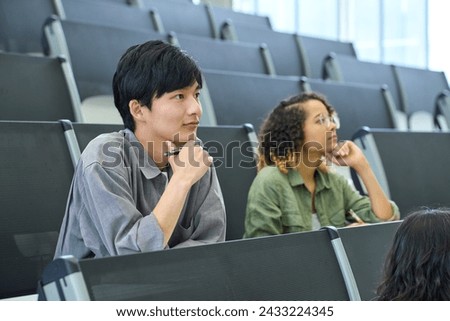 Multinational group of students taking a lecture in the auditorium