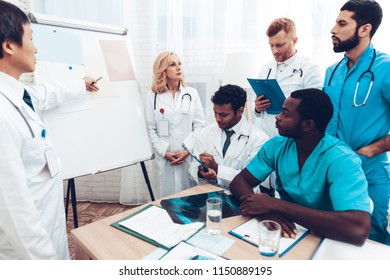 Multinational Medician Consultation. Head Doctor Discussing. Information On Paper Desk. Medical Teamwork Connection. Clinician Team Group. Hospital Diagnostic Meeting. Physician Assistants.