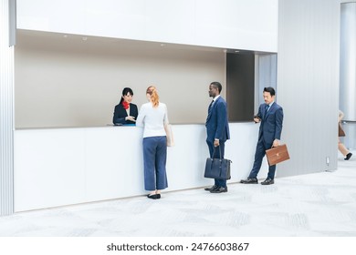 Multinational people checking in at a hotel front desk