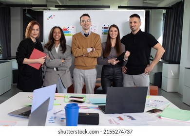 Multinational startup team poses for the camera in the office