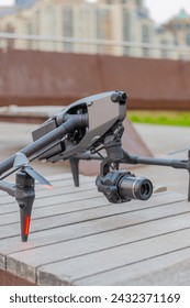 Multi-operator camera drone sitting on a bench