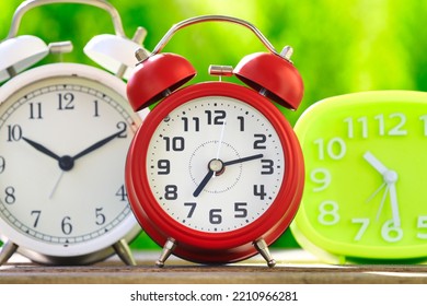 Multiple Alarm Clocks And Green Background